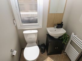 A bathroom with a toilet and sink at Trecco Bay Holiday Park - Magnolia 11 Porthcawl