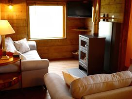 A living room with a couch and wooden stove