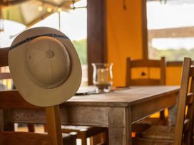 A table with a hat and glass in the dining room