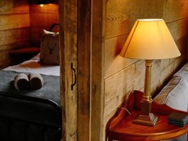 A bedroom with a bed and a lamp on a nightstand at 