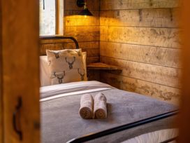 A bedroom with a bed and wooden walls at 