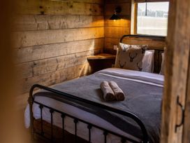 A bedroom with a bed and a bedside table at The Cabin in the Woods