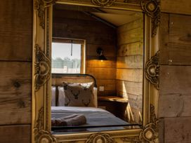 A bedroom with a bed and a mirror at the property name in location