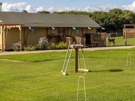 An outdoor area with a tent and deer at a camping site