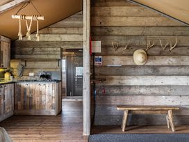 A kitchen with a wood panel wall and a bench at Luxury Safari Lodge Sleeps 4/6 Deer Park Dogs Ok Zeal Monachorum near Bow