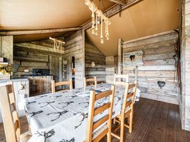 A dining room with a wooden table and chairs at Luxury Safari Lodge Sleeps 4/6 Deer Park Dogs Ok, Zeal Monachorum near Bow