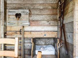 A sleeping area with wooden walls and a bunk bed at Luxury Safari Lodge Sleeps 4/6 Deer Park Dogs Ok Zeal Monachorum near Bow
