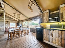 A dining area with a table and chairs at Luxury Safari Lodge Sleeps 4/6 Deer Park Dogs Ok near Zeal Monachorum