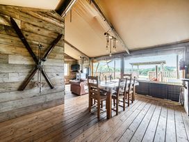 A dining room with wooden furniture and a television at Luxury Safari Lodge Sleeps 4/6 Deer Park Dogs Ok Zeal Monachorum near Bow