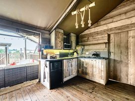 A kitchen with wooden cabinets and appliances at Luxury Safari Lodge Sleeps 4/6 Deer Park Dogs Ok Zeal Monachorum near Bow