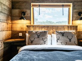 A bedroom with a bed and pillows at Luxury Safari Lodge Sleeps 4/6 Deer Park Dogs Ok Zeal Monachorum near Bow