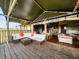 An outdoor living area with seating and dining space at Luxury Safari Lodge Sleeps 4/6 Deer Park Dogs Ok in Zeal Monachorum near Bow