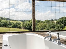 A bathroom with bathtubs and a view at Luxury Safari Lodge Sleeps 4/6 Deer Park Dogs Ok Zeal Monachorum near Bow