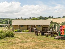 A tent with picnic tables and garden games at Luxury Safari Lodge Sleeps 4/6 Deer Park Dogs Ok Zeal Monachorum near Bow