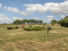 A garden with picnic tables and board games at Luxury Safari Lodge Sleeps 4/6 Deer Park Dogs Ok near Zeal Monachorum near Bow