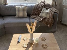 A living room with a sofa, table, and decorative items at the property