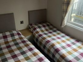 A bedroom with two single beds and a window at 