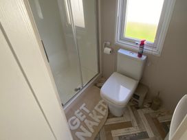 A bathroom with a shower and toilet at 