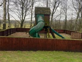 A playground structure with a slide in an outdoor area