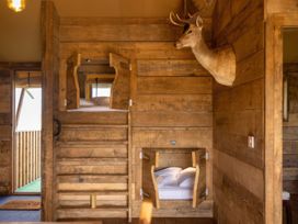 A bedroom with a bunk bed and a deer head mounted on the wall at the property