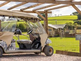 A golf cart under a canopy with a sign in an outdoor area at 