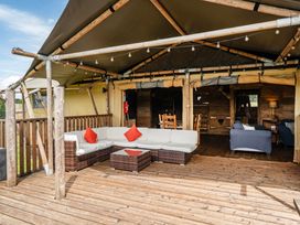An outdoor seating area with a sofa and coffee table at Luxury Safari Lodge Sleeps 4/6 Deer Park Dogs Ok Zeal Monachorum near Bow