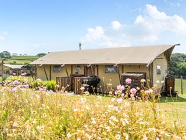 A tent with a deck and grill at Luxury Safari Lodge Sleeps 4/6 Deer Park Dogs Ok Zeal Monachorum near Bow