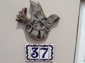 A bird decoration and the number 37 on a wall