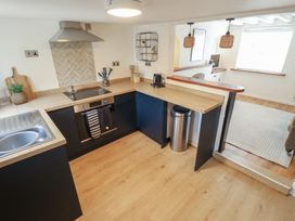 A kitchen with a cooking stove and sink at Pax Cottage 