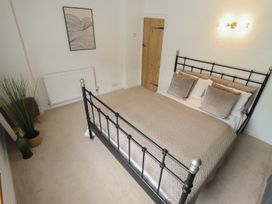A bedroom with a bed and a door at Pax Cottage