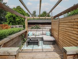A garden seating area with a couch and coffee table at Pax Cottage