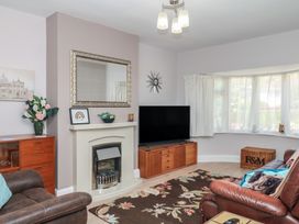 A living room with a television and fireplace at 3 Heath Park Brixham