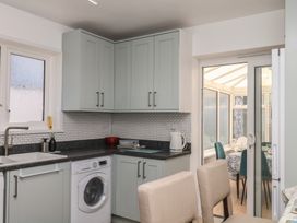 A kitchen with cabinets and appliances at 3 Heath Park in Brixham