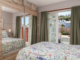 A bedroom with a bed and mirror at 3 Heath Park Brixham