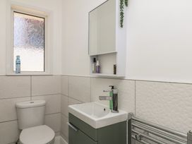 A bathroom with a toilet and sink at 3 Heath Park Brixham