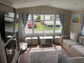 A living room with a sofa and coffee table at Haggerston Castle Lakeside East 76, Berwick-upon-Tweed