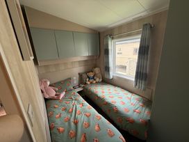 A bedroom with two beds and stuffed toys at Haggerston Castle Lakeside East 76 Berwick-upon-Tweed