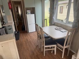 A dining room with a table and chairs at Haggerston Castle Lakeside East 76 Berwick-upon-Tweed