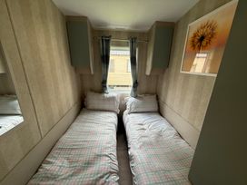 A bedroom with two single beds at Haggerston Castle Lakeside East 76 Berwick-upon-Tweed
