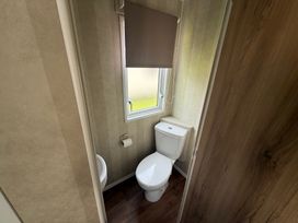 A bathroom with a toilet and a window at Haggerston Castle Lakeside East 76 Berwick-upon-Tweed