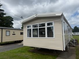 A static caravan with windows and an antenna at Haggerston Castle Lakeside East 76 in Berwick-upon-Tweed