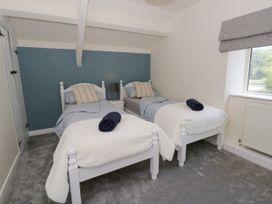A bedroom with two beds and a window at The Cart House in Pontsian