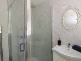 A bathroom with a shower and sink at The Cart House in Pontsian