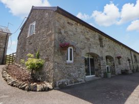 A stone building with windows and a door at The Cart House in Pontsian