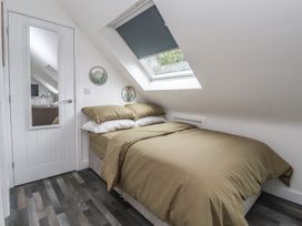 A bedroom with a bed and a mirror at Fields view in Bridlington