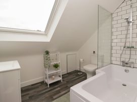 A bathroom with a bathtub and a toilet at Fields view in Bridlington