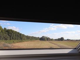 A window view of a field and trees at Fields view in Bridlington