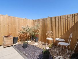 A garden area with two chairs and planters at Fields View in Bridlington