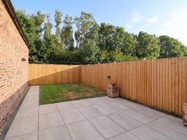 A garden with a patio and grass area at Fields view in Bridlington