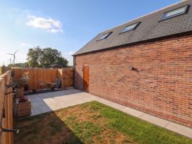 A garden with a brick wall and seating area at Fields view in Bridlington
